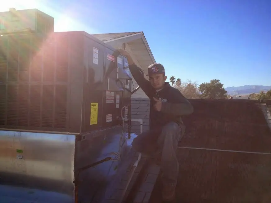 HVAC technician performing AC Tune-Up on a rooftop unit in Union